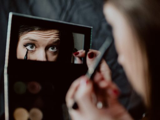 woman holding black framed mirror