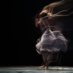 dancing woman on concrete pavement