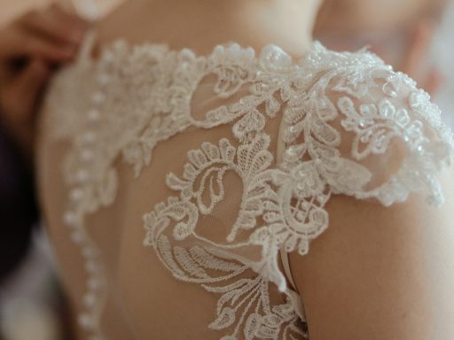 woman wearing white sheer lace wedding gown