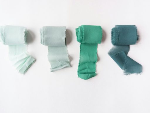 white and teal socks on white surface