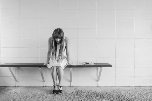 Vrouw kijkt vermoeid in de spiegel en bekijkt haar huid