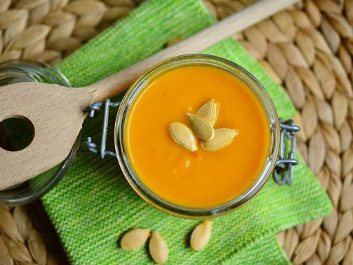Thermosfles met warme soep naast een herfstlunch op een bureau